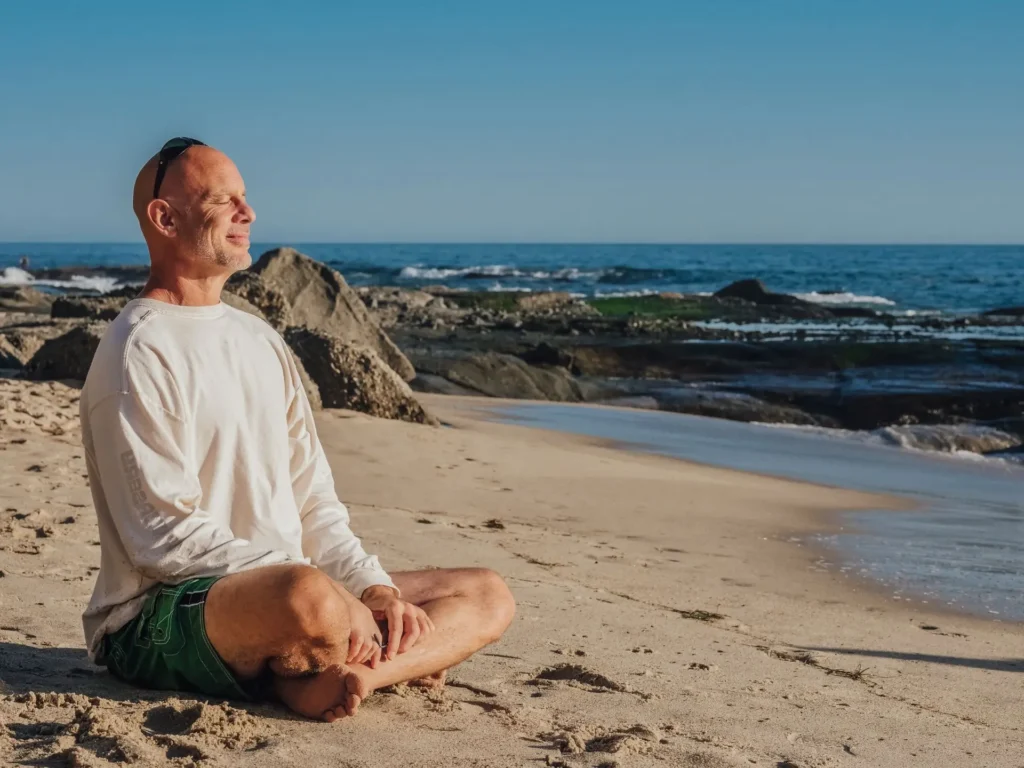 happy man sitting on beach